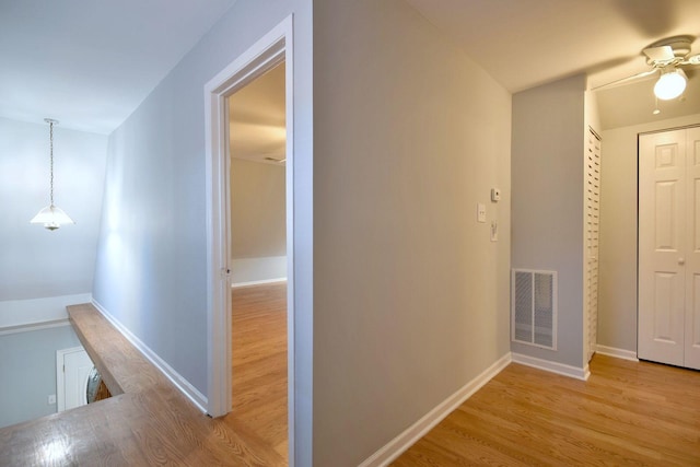 corridor with light hardwood / wood-style flooring