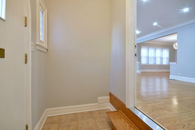 interior space with ornamental molding and light hardwood / wood-style flooring