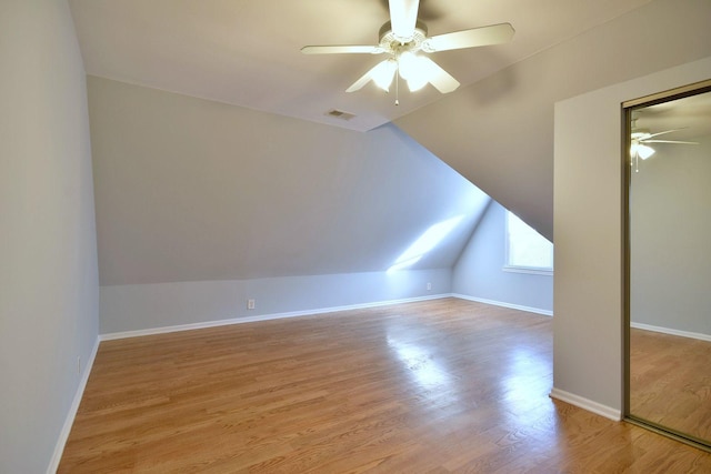 additional living space with ceiling fan, lofted ceiling, and light hardwood / wood-style flooring