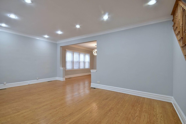 unfurnished room featuring ornamental molding and light hardwood / wood-style flooring