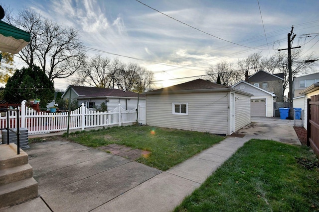 exterior space with a yard, an outbuilding, and a garage