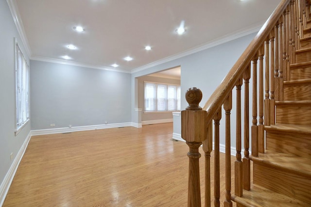 interior space with light hardwood / wood-style floors and ornamental molding