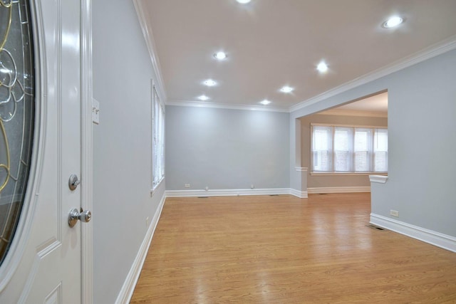 spare room featuring light hardwood / wood-style floors and ornamental molding