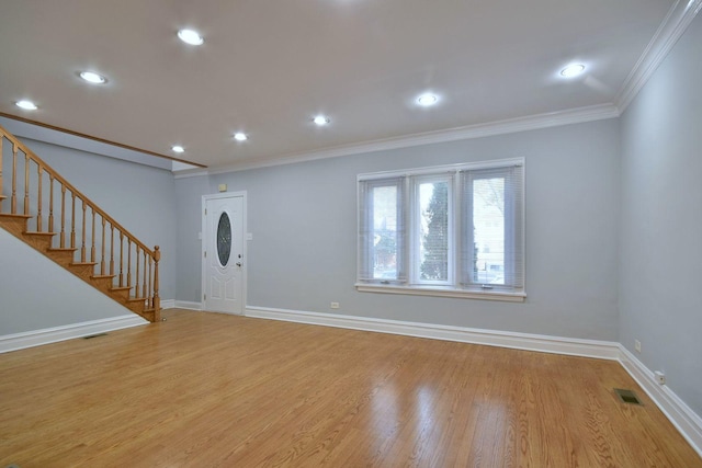 entrance foyer with light wood-type flooring and crown molding