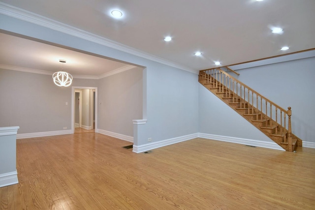 unfurnished living room featuring light wood-type flooring and crown molding