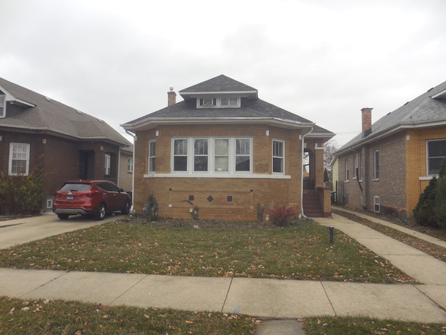 bungalow-style house with a front yard