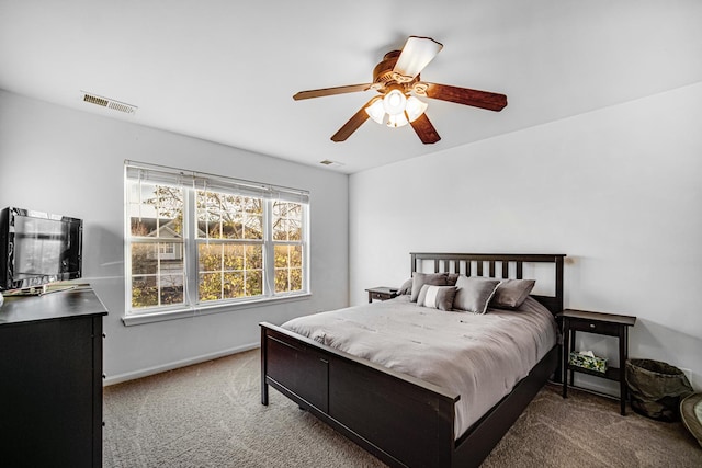 carpeted bedroom with a ceiling fan, baseboards, and visible vents