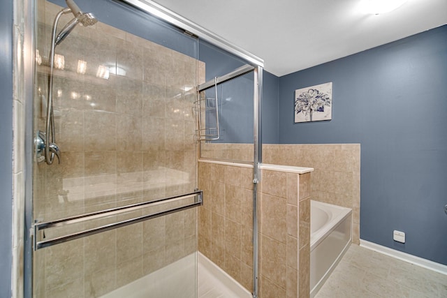 full bath featuring baseboards, tile patterned floors, a bath, and a stall shower