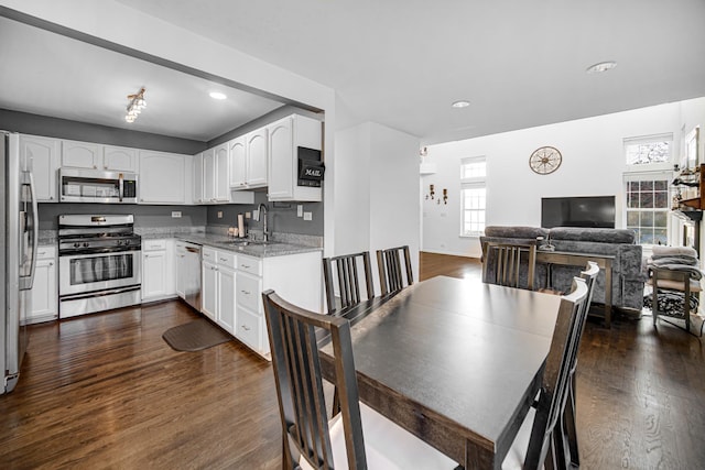 dining space with recessed lighting, baseboards, and dark wood finished floors