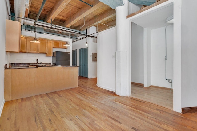 kitchen featuring hanging light fixtures, wooden ceiling, beamed ceiling, light hardwood / wood-style floors, and black refrigerator