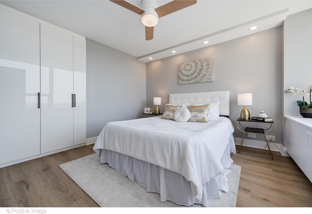 bedroom with ceiling fan and light wood-type flooring