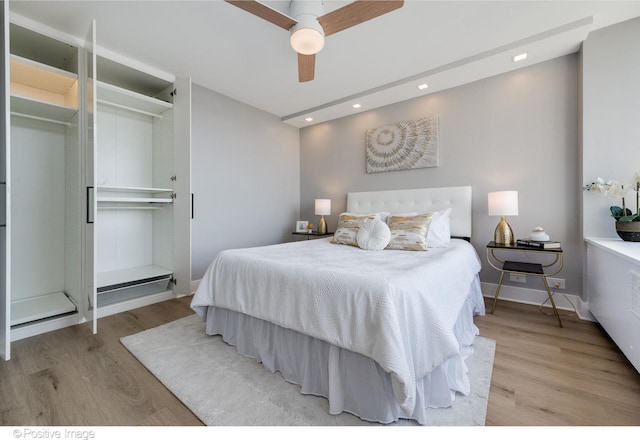 bedroom with ceiling fan and light hardwood / wood-style floors