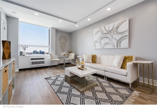 living room featuring wood-type flooring and heating unit