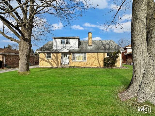 rear view of property with a lawn