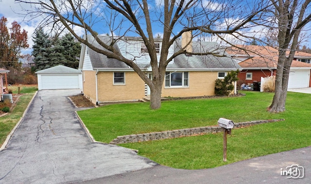 ranch-style house with a front yard, an outbuilding, and a garage