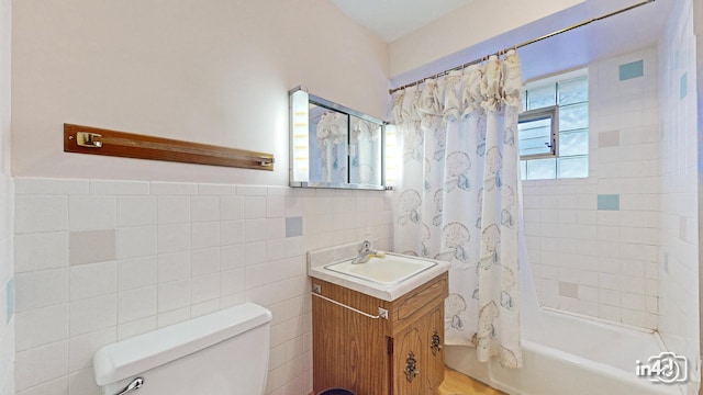 full bathroom with shower / bath combo with shower curtain, vanity, tile walls, and toilet