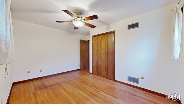 spare room featuring ceiling fan and light hardwood / wood-style floors