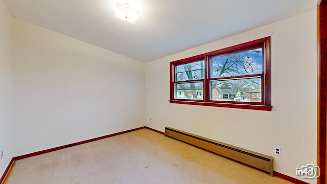 empty room with vaulted ceiling, light colored carpet, and a baseboard radiator