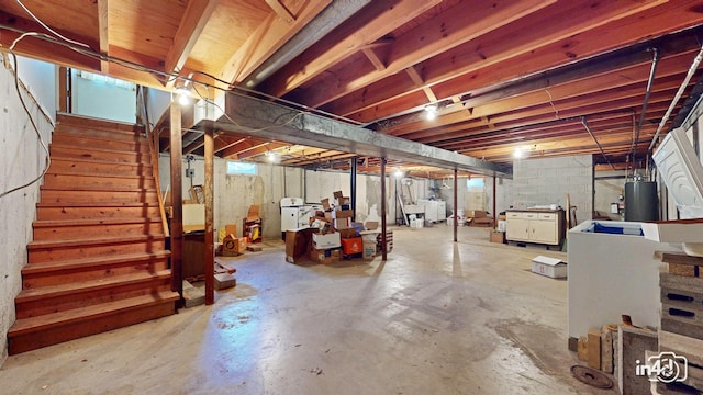 basement featuring gas water heater and washer / clothes dryer