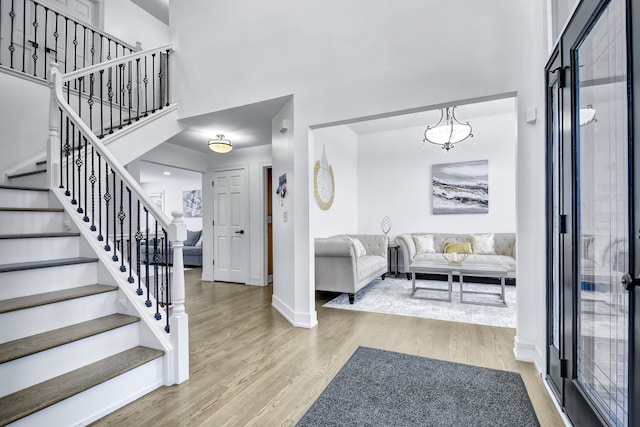 entrance foyer featuring hardwood / wood-style flooring and a notable chandelier