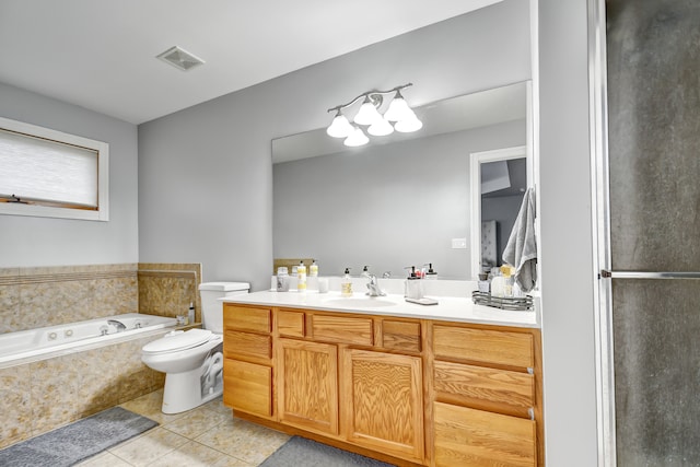 bathroom with visible vents, toilet, vanity, a bath, and tile patterned floors