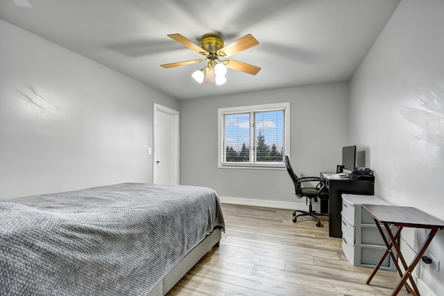 bedroom featuring ceiling fan, baseboards, and wood finished floors