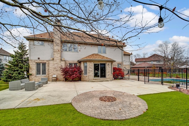 rear view of property with a chimney, fence, an outdoor living space, and a patio