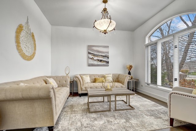 living area featuring a wealth of natural light, baseboards, and wood finished floors