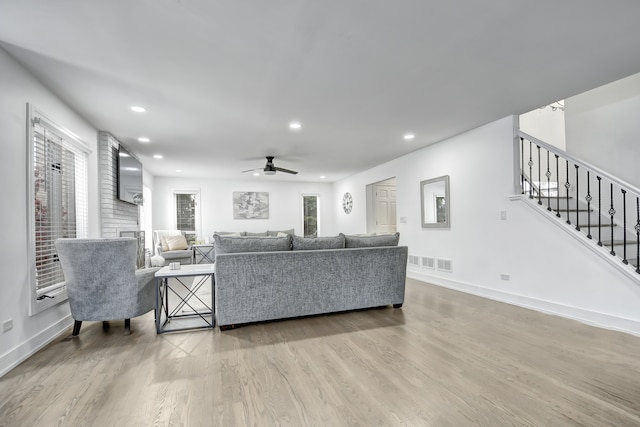 living area with stairs, visible vents, wood finished floors, and recessed lighting