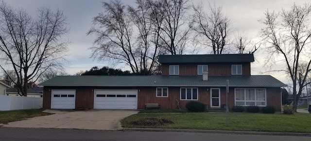 front of property featuring a garage and a front yard