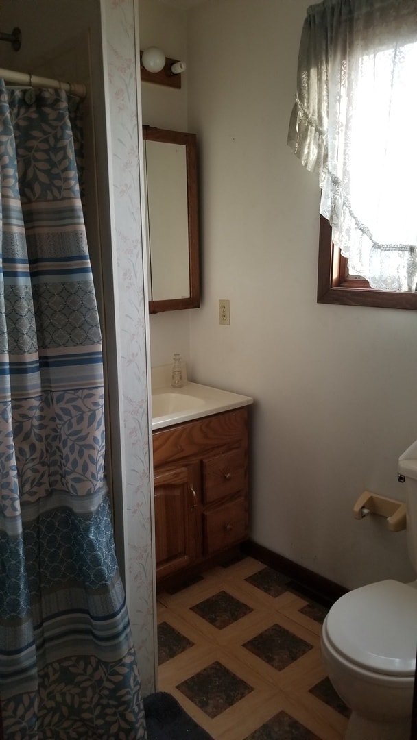 bathroom with tile patterned floors, vanity, and toilet