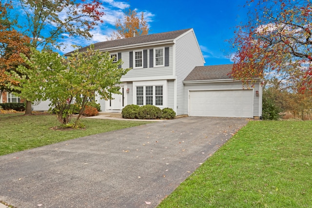 colonial inspired home with a front yard and a garage