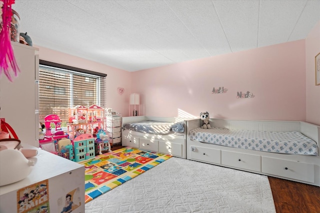 bedroom with dark hardwood / wood-style floors