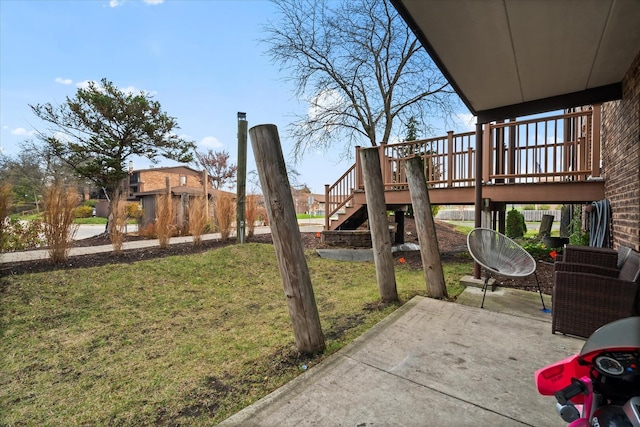 view of yard with a patio area and a wooden deck