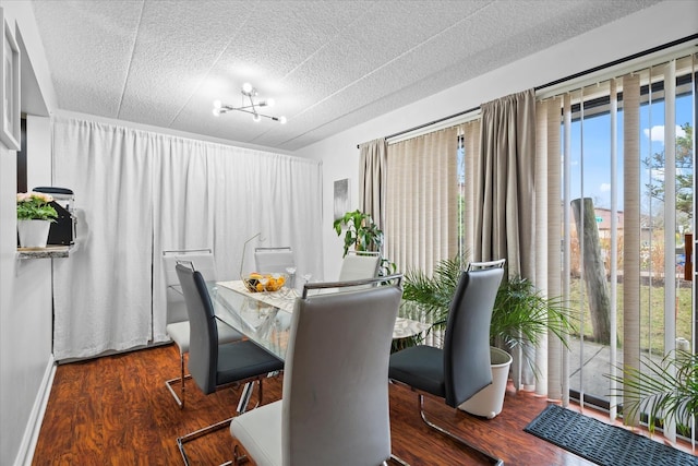 dining room featuring dark hardwood / wood-style floors, a wealth of natural light, and a notable chandelier