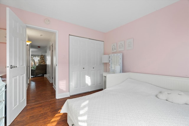 bedroom with a closet and dark wood-type flooring