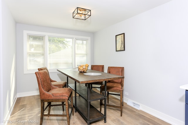 dining space featuring light wood-type flooring