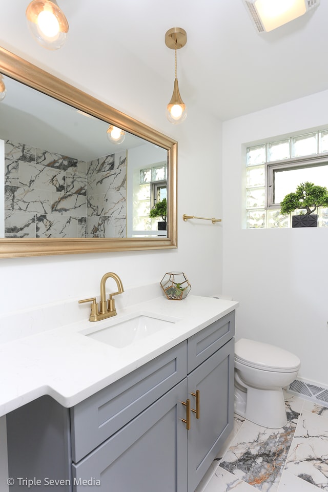 bathroom featuring vanity and toilet