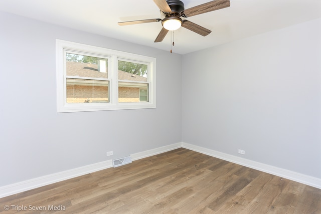 spare room featuring wood-type flooring and ceiling fan