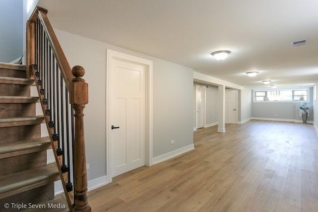 basement with light hardwood / wood-style floors