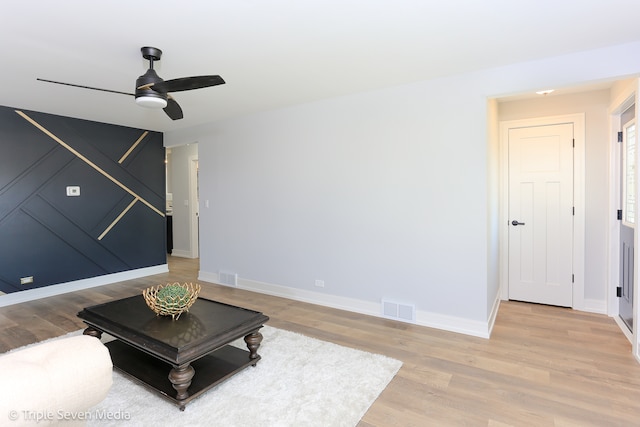 living room with hardwood / wood-style flooring and ceiling fan