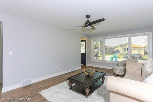 living room featuring ceiling fan and hardwood / wood-style flooring