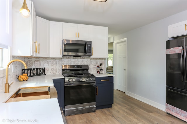 kitchen featuring light hardwood / wood-style floors, sink, white cabinetry, and stainless steel appliances