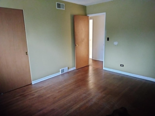 unfurnished bedroom featuring dark hardwood / wood-style floors