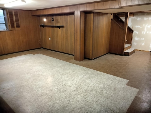 basement featuring wood walls