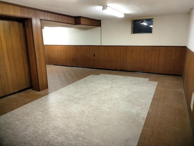 empty room featuring wood walls and light parquet floors