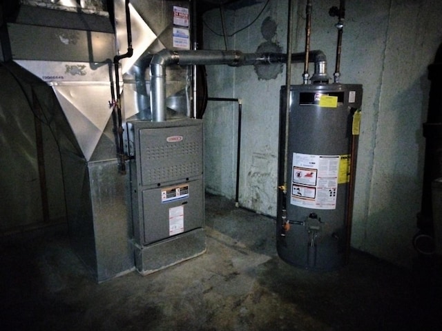 utility room featuring heating unit and water heater