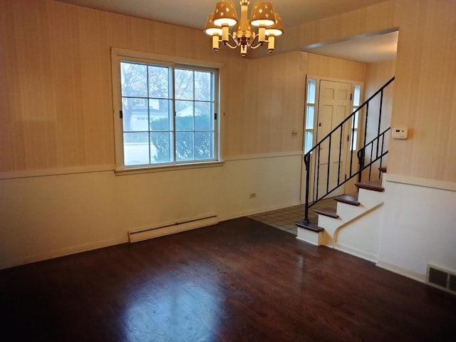 entryway featuring dark hardwood / wood-style floors, an inviting chandelier, and a baseboard heating unit