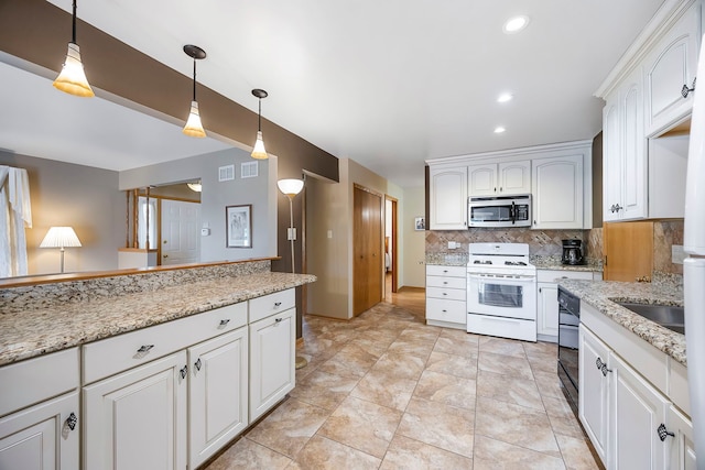 kitchen featuring white cabinetry, backsplash, black dishwasher, light stone countertops, and white range