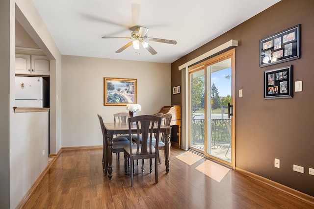 dining space with wood-type flooring and ceiling fan